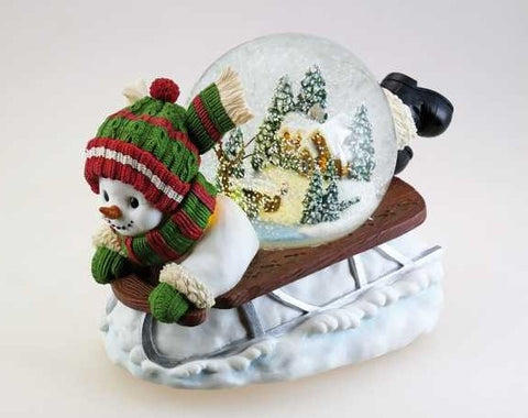 Adorno navideño de 9 cm "Muñeco de nieve en trineo" con melodía