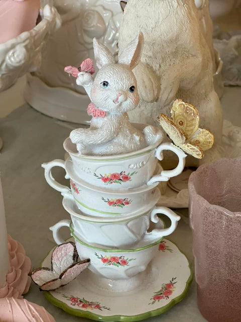 Figurine with cup and butterflies