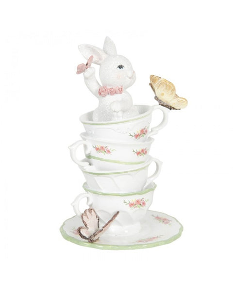 Figurine with cup and butterflies