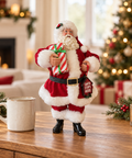 Babbo Natale con dono alto 30 cm ambientato su consolle natalizia